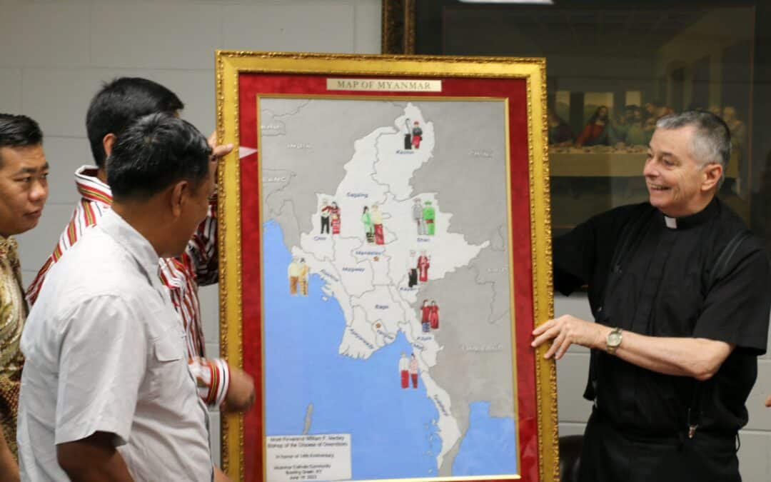 Myanmar Catholics of Bowling Green present map to bishop in gratitude for his support